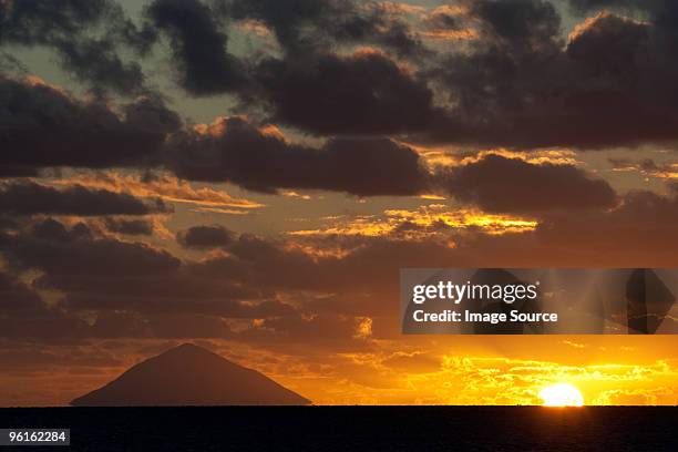 sunset over volcano, kingdom of tonga - tonga photos et images de collection