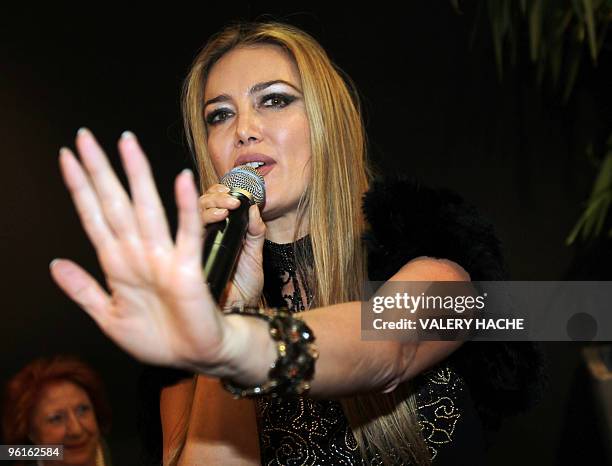 Patrizia d'Addario, the call girl who claims she spent a night with Italian Prime Minister Silvio Berlusconi, sings "All you Want", as she presents...