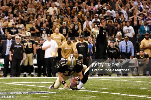 Kicker Garrett Hartley of the New Orleans Saints successfully kicks a 40-yard game-winning field goal in overtime from the hold of Mark Brunell...