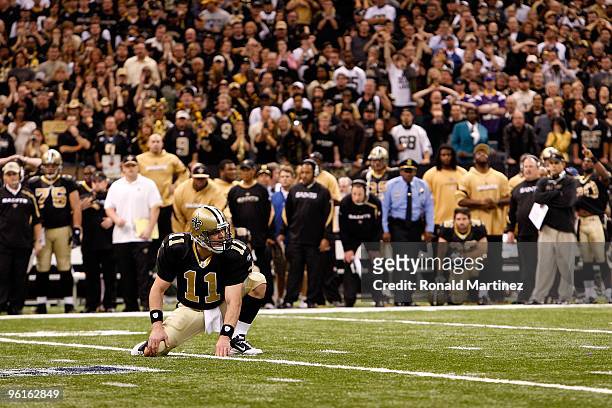 Mark Brunell of the New Orleans Saints looks back to the kicker as he gets set to hold on the 40-yard game-winning field goal against the Minnesota...