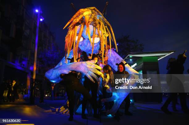 People get up close and personal with the puppet creature named Marri Dyin during a media preview for Vivid Sydney on May 23, 2018 in Sydney,...