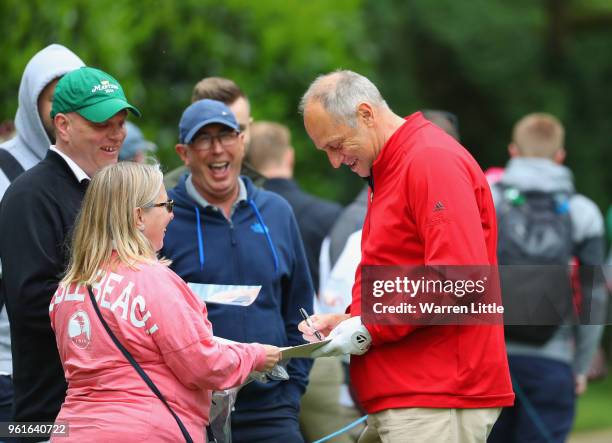 Former Olympic rower Sir Steve Redgrave signs autographs for spectators during the BMW PGA Championship Pro Am tournament at Wentworth on May 23,...