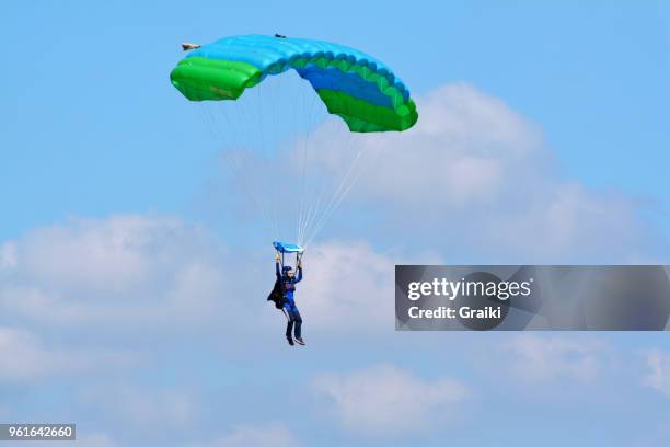 parachute woman flying in the blue sky - parachute stock pictures, royalty-free photos & images