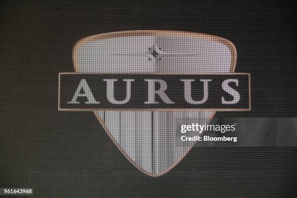 The logo of the Aurus Oo automotive brand is displayed on a screen during a news conference in Moscow, Russia, on Wednesday, May 23, 2018. Sollers...