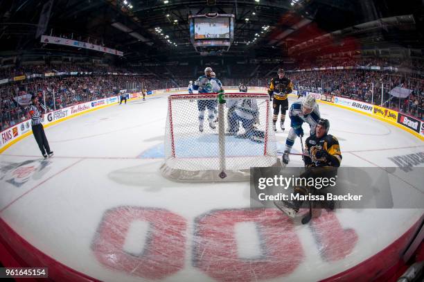 Robert Thomas of the Hamilton Bulldogs is checked by Noah King behind the net of Stuart Skinner of the Swift Current Broncos during first period at...