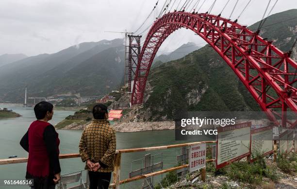 People stand in front of the construction site of Xiangxi Bridge over the Yangtze River on May 22, 2018 in Yichang, China. Xiangxi Yangtze River...