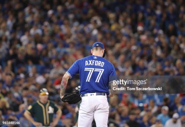 John Axford of the Toronto Blue Jays stands on the mound before delivering a pitch in the eighth inning during MLB game action against the Oakland...