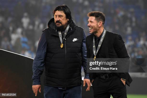 Atletico Madrid head coach Diego Simeone and assistant coach German Burgos are seen at the medal ceremony after the UEFA Europa League Final between...