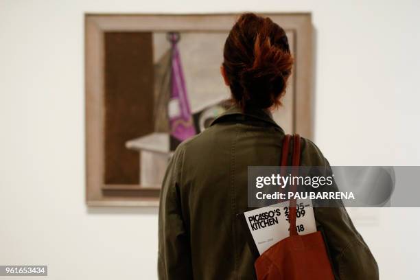 Visitor looks at a painting by Spanish artist Pablo Picasso during the presentation of the exhibition "Picasso's Kitchen" at the Picasso Museum in...