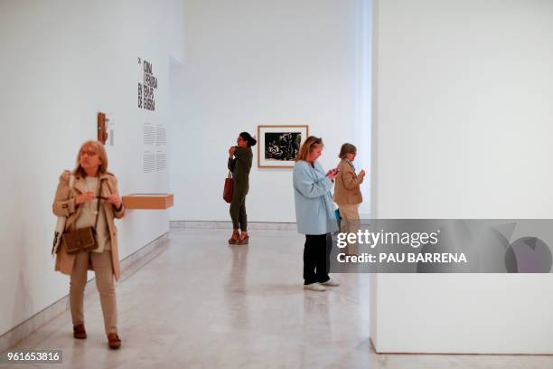 People look at paintings by Spanish artist Pablo Picasso during the presentation of the exhibition "Picasso's Kitchen" at the Picasso Museum in...
