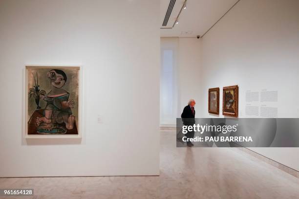 Man looks at paintings by Spanish artist Pablo Picasso near "Young Boy with Lobster" during the presentation of the exhibition "Picasso's Kitchen" at...