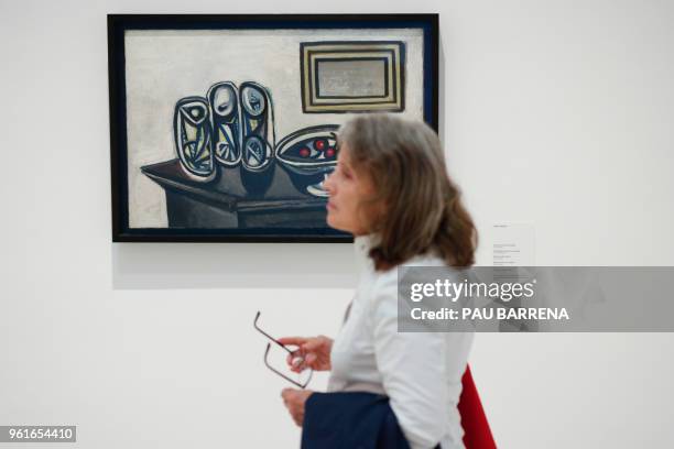 Woman walks past "Still Life with Cherries" by Spanish artist Pablo Picasso during the presentation of the exhibition "Picasso's Kitchen" at the...