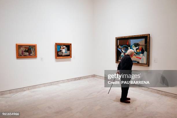 Man looks at paintings by Spanish artist Pablo Picasso during the presentation of the exhibition "Picasso's Kitchen" at the Picasso Museum in...