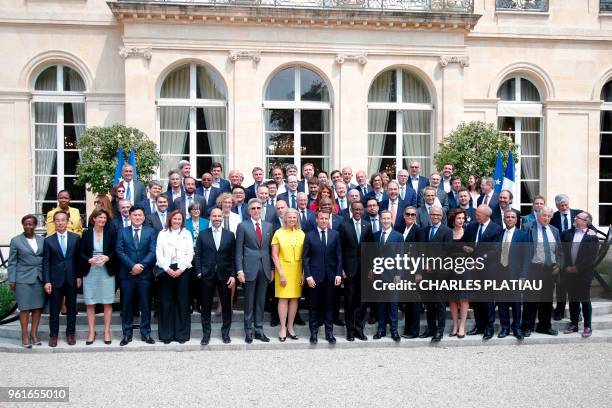 French President Emmanuel Macron poses for a family picture with Rwanda's President Paul Kagame , Facebook's founder and CEO Mark Zuckerberg and...