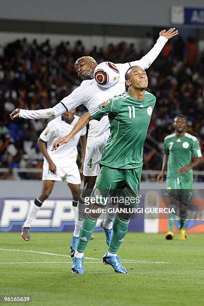 Peter Odemwingie of Nigeria and Joseph Musonda of Zambia jump for the ball during their quarter final match at the African Cup of Nations CAN2010 at...