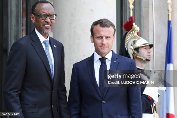 France's President Emmanuel Macron welcomes Rwanda's President Paul Kagame upon his arrival at the Elysee presidential palace in Paris, on May 23,...