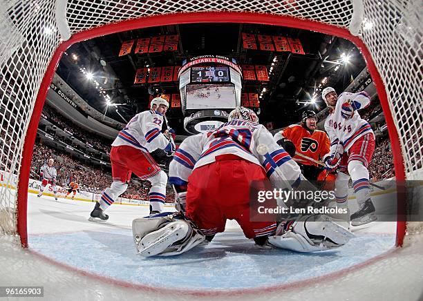 Scott Hartnell of the Philadelphia Flyers takes a shot on goaltender Henrik Lundqvist of the New York Rangers while Brian Boyle and Michal Rozsival...