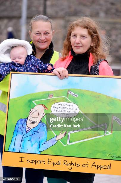 Twelve-week-old Riley Stuart dozes as Mum Sara Martin , Shaeron Averbuch , and other planning campaigners demonstrate outside the Scottish Parliament...