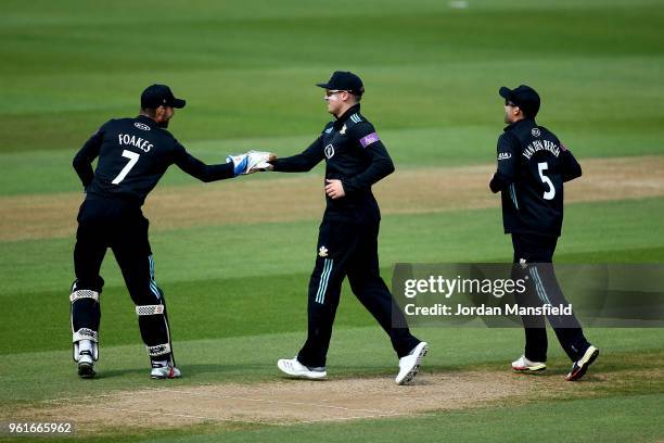 Jason Roy of Surrey celebrates with Ben Foakes of Surrey afte dismissing George Hankins of Gloucestershire during the Royal London One-Day Cup match...