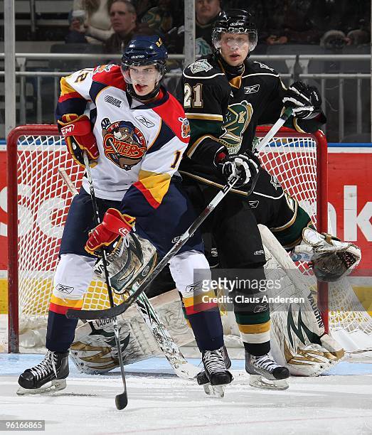 Andrew Yogan of the Erie Otters is tied up by Kalle Ekelund of the London Knights in a game on January 22, 2010 at the John Labatt Centre in London,...