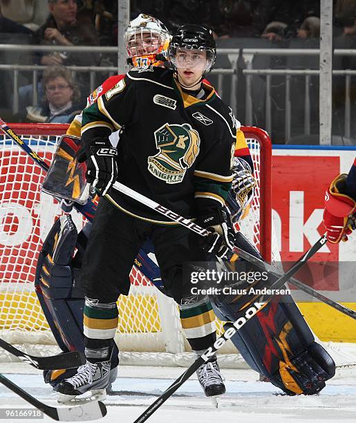 Michael MacDonald of the London Knights waits to tip a shot in front of Ramis Sadikov of the Erie Otters in a game on January 22, 2010 at the John...