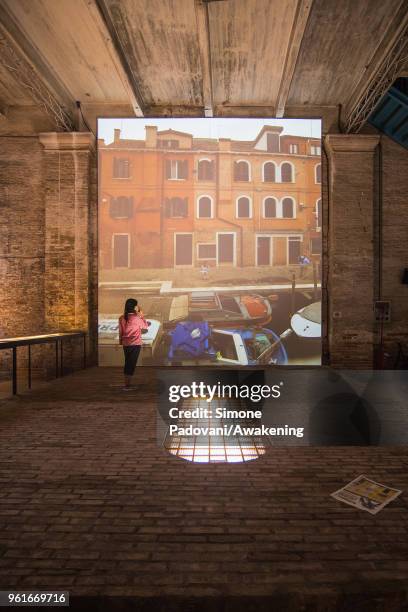 Performer looks at the Rozana Montiel Estudio de Arquitectura installation in the Corderie of Arsenale at the 16th International Architecture...