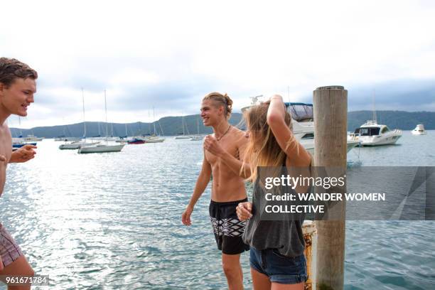 group of young adults having fun at the end of a jetty - pittwater stock pictures, royalty-free photos & images