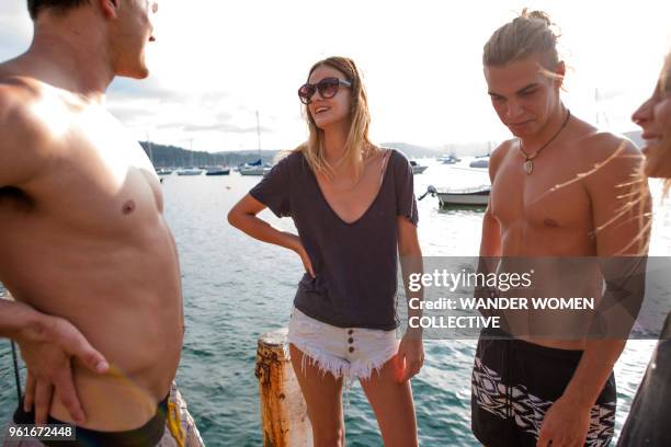 group of young adult friends hanging out on an australian jetty - pittwater stock pictures, royalty-free photos & images