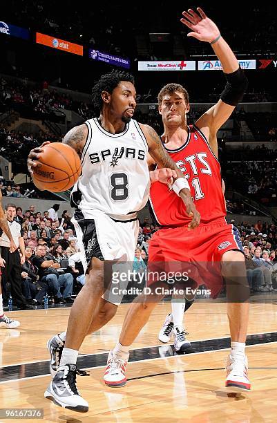 Roger Mason Jr. #8 of the San Antonio Spurs drives against Brook Lopez of the New Jersey Nets during the game on January 10, 2010 at the AT&T Center...