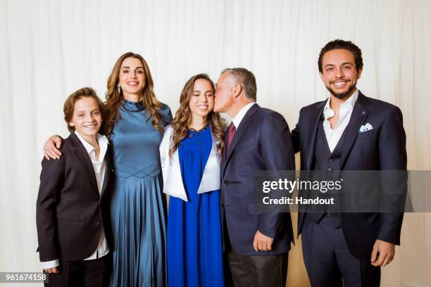 In this handout image provided by the Royal Hashemite Court, Jordan's King Abdullah II , his wife Queen Rania and , Crown Prince Al Hussein and...