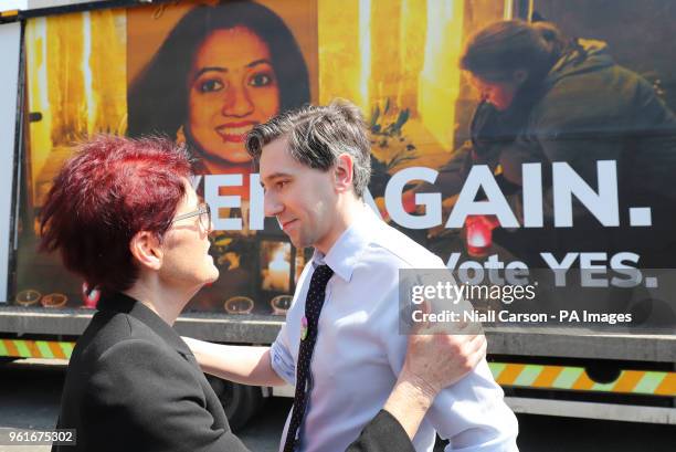 Ailbhe Smyth Convenor of the Coalition to Repeal the Eighth Amendment hugs Health Minister Simon Harris during a Together for Yes billboard launch in...