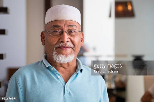 portrait of a senior malaysian man - islam man stock pictures, royalty-free photos & images