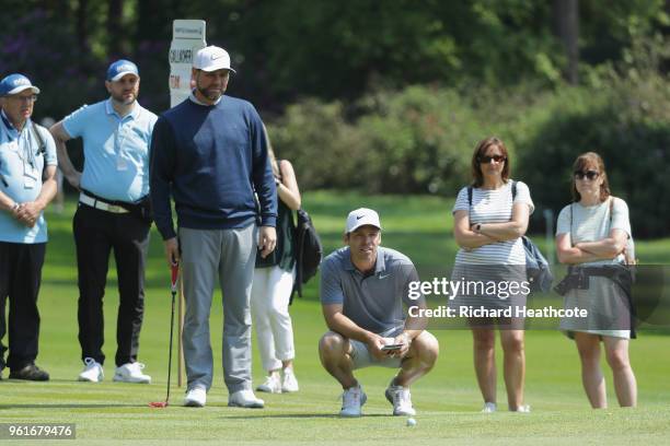 Brian McFadden lines up a putt with Paul Casey of England during the Pro Am for the BMW PGA Championship at Wentworth on May 23, 2018 in Virginia...