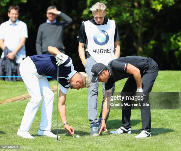 Reality TV star Chris Hughes and Danny Willett of England discuss a shot during the BMW PGA Championship Pro Am tournament at Wentworth on May 23,...