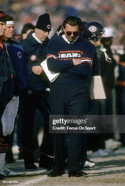 S: Head Coach Mike Ditka of the Chicago Bears with his arms folded walks up and down the sidelines during a mid circa 1980's NFL football game at...