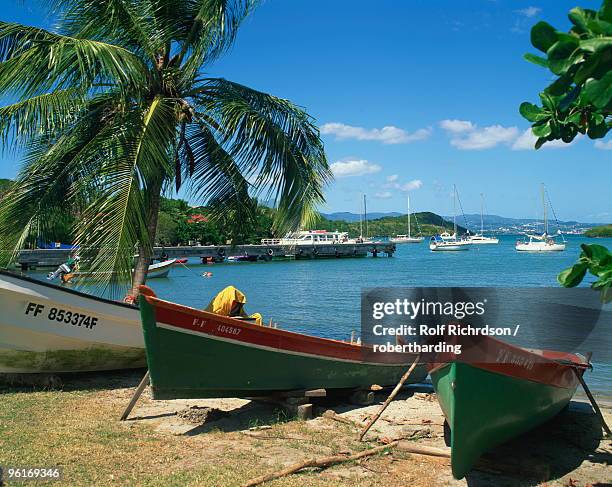 fishing boats pulled up onto the beach at trois ilets harbour, martinique, lesser antilles, west indies, caribbean, central america - martinique beach stock pictures, royalty-free photos & images