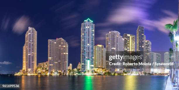 panoramic of the downtown miami skyline from brickell key, miami, florida, united states - miami skyline night stock pictures, royalty-free photos & images