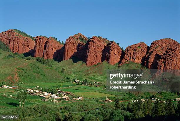 village below rock formation called dzhety-oguz, the seven wild bulls, near kara kol in kyrgyzstan, central asia, asia - kol stock pictures, royalty-free photos & images