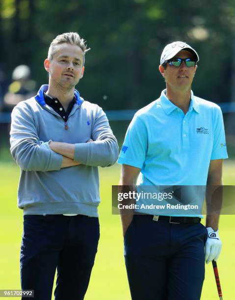 Musician Tom Chaplin and Nicolas Colsaerts of Belgium look on during the BMW PGA Championship Pro Am tournament at Wentworth on May 23, 2018 in...