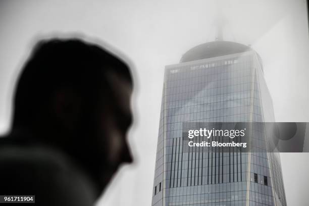 One World Trade Center is seen past an attendee on the 68th floor of the 3 World Trade Center building during a tour in New York, U.S., on Tuesday,...