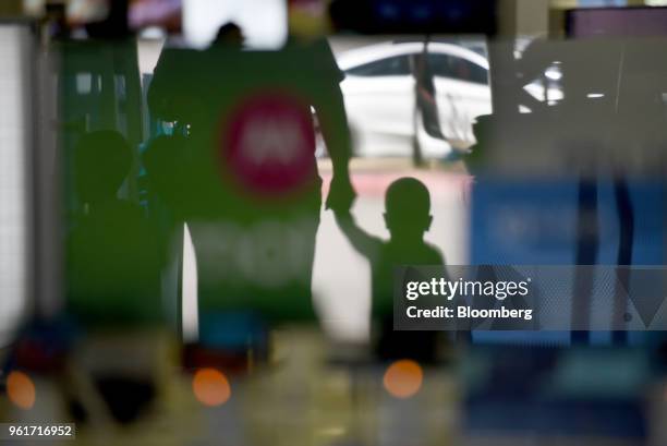The silhouettes of customers are seen entering a Best Buy Co. Store in San Antonio, Texas, U.S., on Thursday, May 17, 2018. Best Buy Co. Is scheduled...