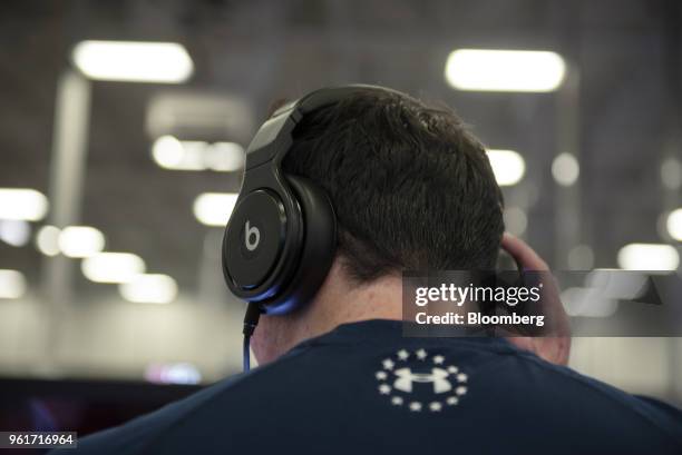Customer tries on a pair of Beats Electronics LLC headphones at a Best Buy Co. Store in San Antonio, Texas, U.S., on Thursday, May 17, 2018. Best Buy...