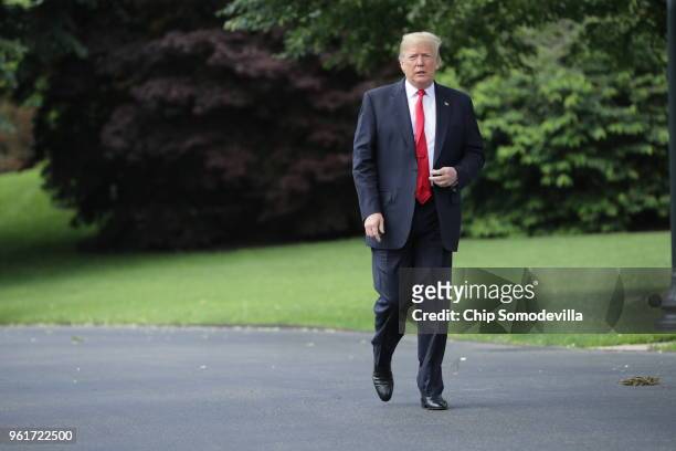 President Donald Trump walks across the South Lawn while departing the White House May 23, 2018 in Washington, DC. Trump is traveling to New York...