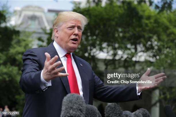 President Donald Trump speaks to the media as he walks across the South Lawn while departing the White House May 23, 2018 in Washington, DC. Trump is...