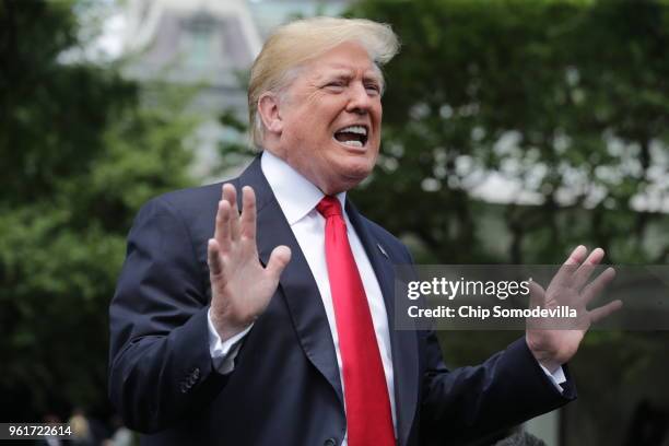 President Donald Trump speaks to the media as he walks across the South Lawn while departing the White House May 23, 2018 in Washington, DC. Trump is...