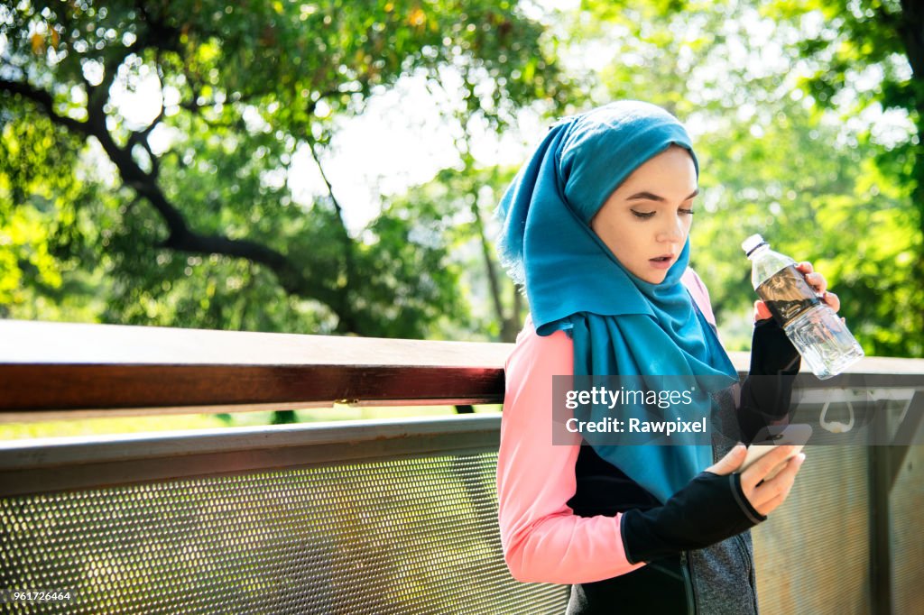 Islamic woman resting and drinking water
