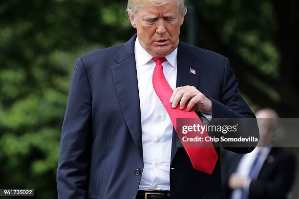 President Donald Trump walks along the south driveway before departing the White House May 23, 2018 in Washington, DC. Trump is traveling to New York...