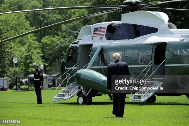 President Donald Trump walks across the South Lawn before boarding Marine One and departing the White House May 23, 2018 in Washington, DC. Trump is...