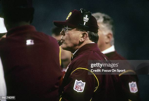 Head coach of the Washington Redskins Joe Gibbs watches the action from the sidelines during a mid circa 1980s NFL football game. Gibbs coached the...