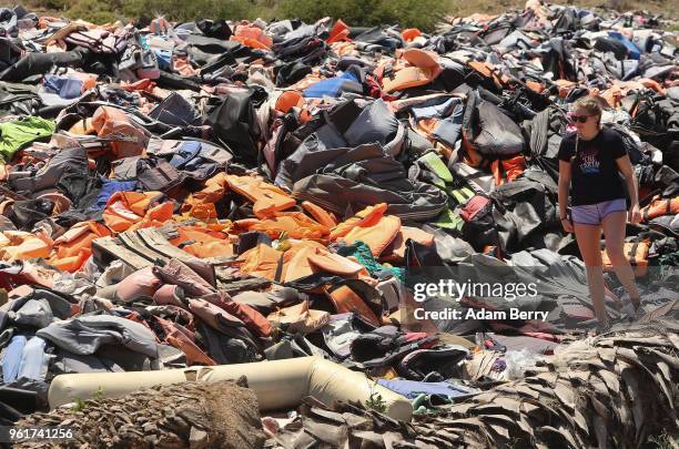 Thousands of used life preservers and pieces of rafts used by refugees in their attempted crossings from Turkey to Greece lay in a pile on the island...